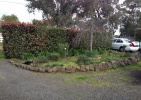 BEFORE - Brendan's front yard garden bed was overgrown.