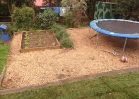 AFTER - After a general tidy up and plenty of wood chips, this area is great for the kids.