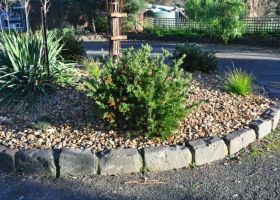 Fiona's driveway forms a turning circle with a simple native garden in the centre.